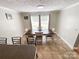 Bright dining area featuring tile floors, a wooden table, and natural light from the windows at 4285 Palmer Lloyd Rd, Lancaster, SC 29720