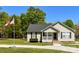 Charming single-story home with a well-maintained lawn, American flag and a gravel driveway at 4285 Palmer Lloyd Rd, Lancaster, SC 29720