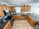 Well-lit kitchen with stainless steel appliances, wooden cabinets and patterned tile floor at 4285 Palmer Lloyd Rd, Lancaster, SC 29720