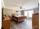 Spacious main bedroom featuring a ceiling fan, gray plank flooring, and natural light from two windows at 4285 Palmer Lloyd Rd, Lancaster, SC 29720