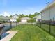 Fenced backyard with green grass in a residential neighborhood at 4303 Patriots Hill Rd, Mint Hill, NC 28227