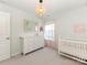Bright Bedroom featuring a crib, white dresser, and soft pink accents at 4303 Patriots Hill Rd, Mint Hill, NC 28227