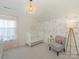 Charming Bedroom with a crib, decorative wallpaper, and accent chair at 4303 Patriots Hill Rd, Mint Hill, NC 28227