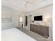Comfortable primary bedroom with closet access, and a dresser with television at 4303 Patriots Hill Rd, Mint Hill, NC 28227