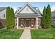 Charming brick home featuring a cozy front porch with seating and meticulously maintained landscaping at 4303 Patriots Hill Rd, Mint Hill, NC 28227