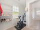 Bright workout room features an exercise bike, shoe rack, and access to the bathroom at 4303 Patriots Hill Rd, Mint Hill, NC 28227