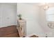 Elegant hallway with hardwood floors, a decorative table, and stylish light fixture at 4303 Patriots Hill Rd, Mint Hill, NC 28227