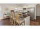 Modern kitchen with stainless steel appliances, a center island with seating, and ample counter space at 4303 Patriots Hill Rd, Mint Hill, NC 28227