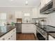 Well-lit kitchen with white cabinetry, stainless steel appliances, and beautiful countertop at 4303 Patriots Hill Rd, Mint Hill, NC 28227