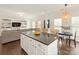 Open-concept living space with a kitchen island overlooking a comfortable living room at 4303 Patriots Hill Rd, Mint Hill, NC 28227