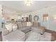 Bright, open-concept living area with a comfortable sectional sofa and seamless access to the kitchen at 4303 Patriots Hill Rd, Mint Hill, NC 28227