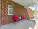 Cozy brick patio with red seating, perfect for relaxing outdoors at 4303 Patriots Hill Rd, Mint Hill, NC 28227