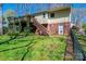 Landscaped backyard with a wooden deck, stairs, and a fenced perimeter providing privacy at 5451 Gunpowder Dr, Hickory, NC 28601