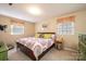 Cozy bedroom with neutral walls and carpet, natural light, wood bed frame, and colorful quilt on the bed at 5451 Gunpowder Dr, Hickory, NC 28601