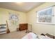 Bedroom with neutral walls and carpet, natural light, wood dresser, and broom leaning against the wall at 5451 Gunpowder Dr, Hickory, NC 28601