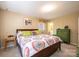 Cozy bedroom with neutral walls and carpet, natural light, wood bed frame, and colorful quilt on the bed at 5451 Gunpowder Dr, Hickory, NC 28601