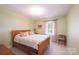 Comfortable bedroom featuring a wood bed frame, neutral walls, and cozy decor at 5451 Gunpowder Dr, Hickory, NC 28601