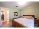 Bedroom with wood bed frame, plush bedding, side table, and connecting door to the bathroom at 5451 Gunpowder Dr, Hickory, NC 28601