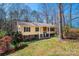 Charming yellow two-story home featuring a covered porch, brick accents, and mature trees at 5451 Gunpowder Dr, Hickory, NC 28601