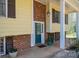 Inviting front entrance with brick accents, covered porch, and a stylish teal front door at 5451 Gunpowder Dr, Hickory, NC 28601