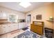 Traditional kitchen area featuring white cabinets, appliances, a window and tile flooring that is easy to clean and care for at 5451 Gunpowder Dr, Hickory, NC 28601