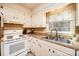 Traditional kitchen features white cabinets, appliances, countertops, large stainless sink and window with great natural light at 5451 Gunpowder Dr, Hickory, NC 28601