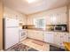 Traditional kitchen featuring white cabinets, appliances, window, and tile flooring for an easy to maintain and bright space at 5451 Gunpowder Dr, Hickory, NC 28601