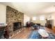 Cozy living room with a stone fireplace, hardwood floors, and comfortable seating at 5451 Gunpowder Dr, Hickory, NC 28601