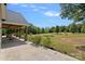 Beautiful covered patio with wooden columns overlooks a sprawling yard with a garden at 5546/5510 Hoodtown Rd, Sharon, SC 29742