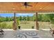 Inviting covered patio with wood ceiling overlooks a sprawling yard with mature trees and landscaping at 5546/5510 Hoodtown Rd, Sharon, SC 29742
