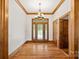 Inviting foyer with hardwood floors, decorative chandelier, and wood trim at 5546/5510 Hoodtown Rd, Sharon, SC 29742