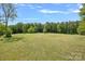 Spacious green yard with mature trees, offering a serene and private outdoor space at 5546/5510 Hoodtown Rd, Sharon, SC 29742