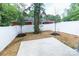 Well-maintained backyard with a white fence, concrete patio, and fresh landscaping at 615 Billingsley Rd, Charlotte, NC 28211