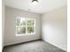 Neutral bedroom with plush carpeting and a large window offering ample natural light at 615 Billingsley Rd, Charlotte, NC 28211