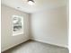 Bedroom with a large window and cozy carpeting for warmth and comfort at 615 Billingsley Rd, Charlotte, NC 28211