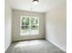 Bedroom showcasing a large window and soft carpeting, perfect for relaxation at 615 Billingsley Rd, Charlotte, NC 28211
