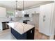 Kitchen with white cabinets, stainless appliances, and island with marble-look countertop at 615 Billingsley Rd, Charlotte, NC 28211