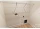 Unfinished laundry room with new flooring and hookups for washer and dryer at 615 Billingsley Rd, Charlotte, NC 28211