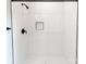 Tiled shower with black fixtures and a built-in niche for bathroom essentials at 615 Billingsley Rd, Charlotte, NC 28211