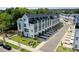 Aerial view of modern townhomes, showing roof top decks, private garages, and surrounding green space at 648 W End Dr, Charlotte, NC 28208