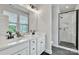 Modern bathroom featuring double sinks, white countertops, and a glass-enclosed shower at 648 W End Dr, Charlotte, NC 28208