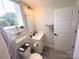 Bright bathroom featuring a shower/tub combo, white vanity, and a window with natural light at 648 W End Dr, Charlotte, NC 28208