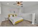 Comfortable bedroom boasts plush carpet, a stylish ceiling fan, and ample natural light at 648 W End Dr, Charlotte, NC 28208