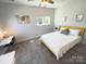 Bright bedroom featuring carpet, a sunny window, desk and yellow bedframe at 648 W End Dr, Charlotte, NC 28208