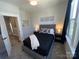Cozy bedroom featuring a plush bed, two side tables with lamps, and modern decor at 648 W End Dr, Charlotte, NC 28208