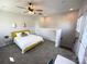 This bright bedroom features carpet, a ceiling fan and stairway access to other floors at 648 W End Dr, Charlotte, NC 28208