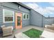 The spacious outdoor deck features stylish furniture, a vibrant green turf rug, and a sleek gray facade at 648 W End Dr, Charlotte, NC 28208