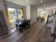 Bright dining area with black table, leading to the living room featuring yellow chairs at 648 W End Dr, Charlotte, NC 28208