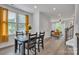 Open-concept dining room with hardwood floors, connecting to the living room and bathed in natural light at 648 W End Dr, Charlotte, NC 28208