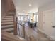 View of the staircase and kitchen featuring an island and a dining area at 648 W End Dr, Charlotte, NC 28208